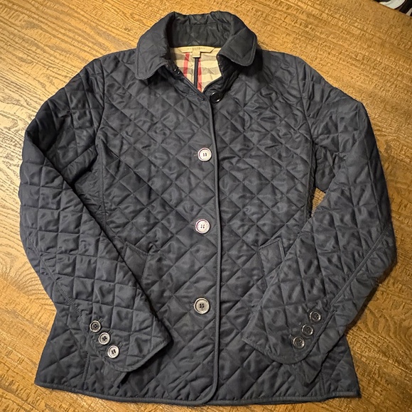 This is a navy blue Burberry quilted jacket with a signature check lining. - Picture 2 of 7